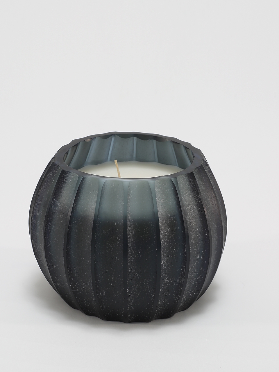 Atolla Blue Bottle Candle burning, releasing Red Santal fragrance in handcrafted blue glass vessel