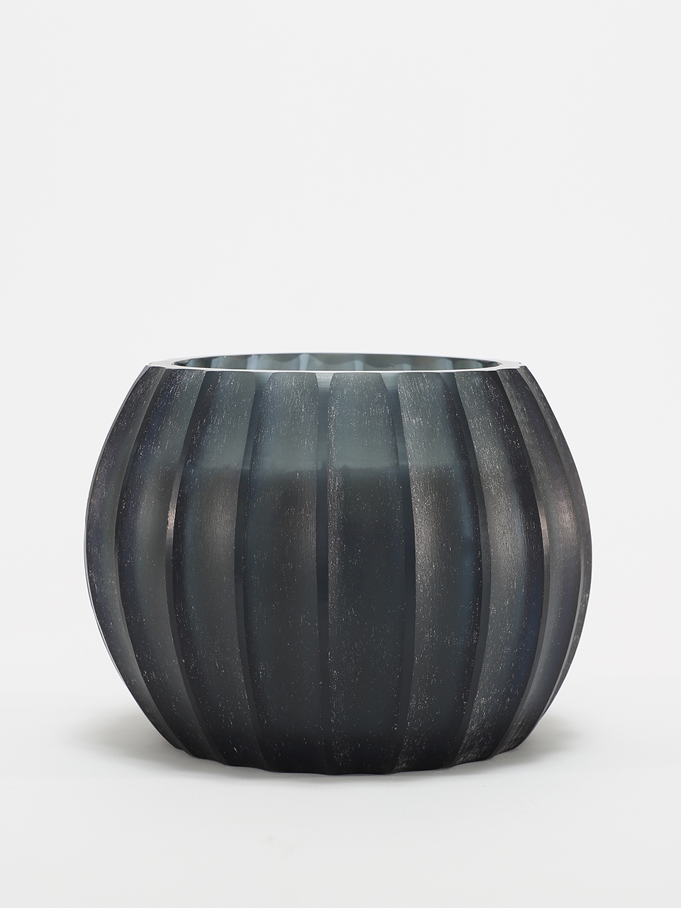 Atolla Blue Bottle Candle burning, releasing Red Santal fragrance in handcrafted blue glass vessel