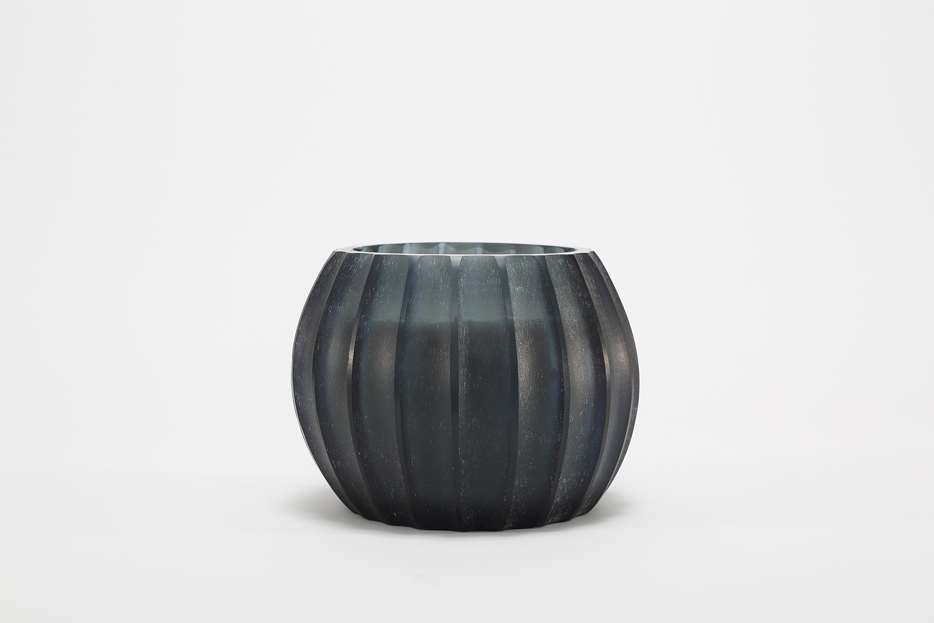 Atolla Blue Bottle Candle burning, releasing Red Santal fragrance in handcrafted blue glass vessel