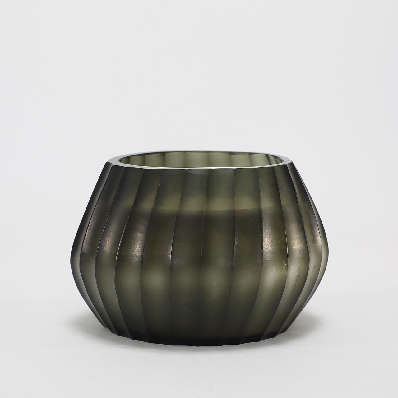 Aura Moss Candle burning, releasing Wanderlust fragrance in hand-carved glass vessel