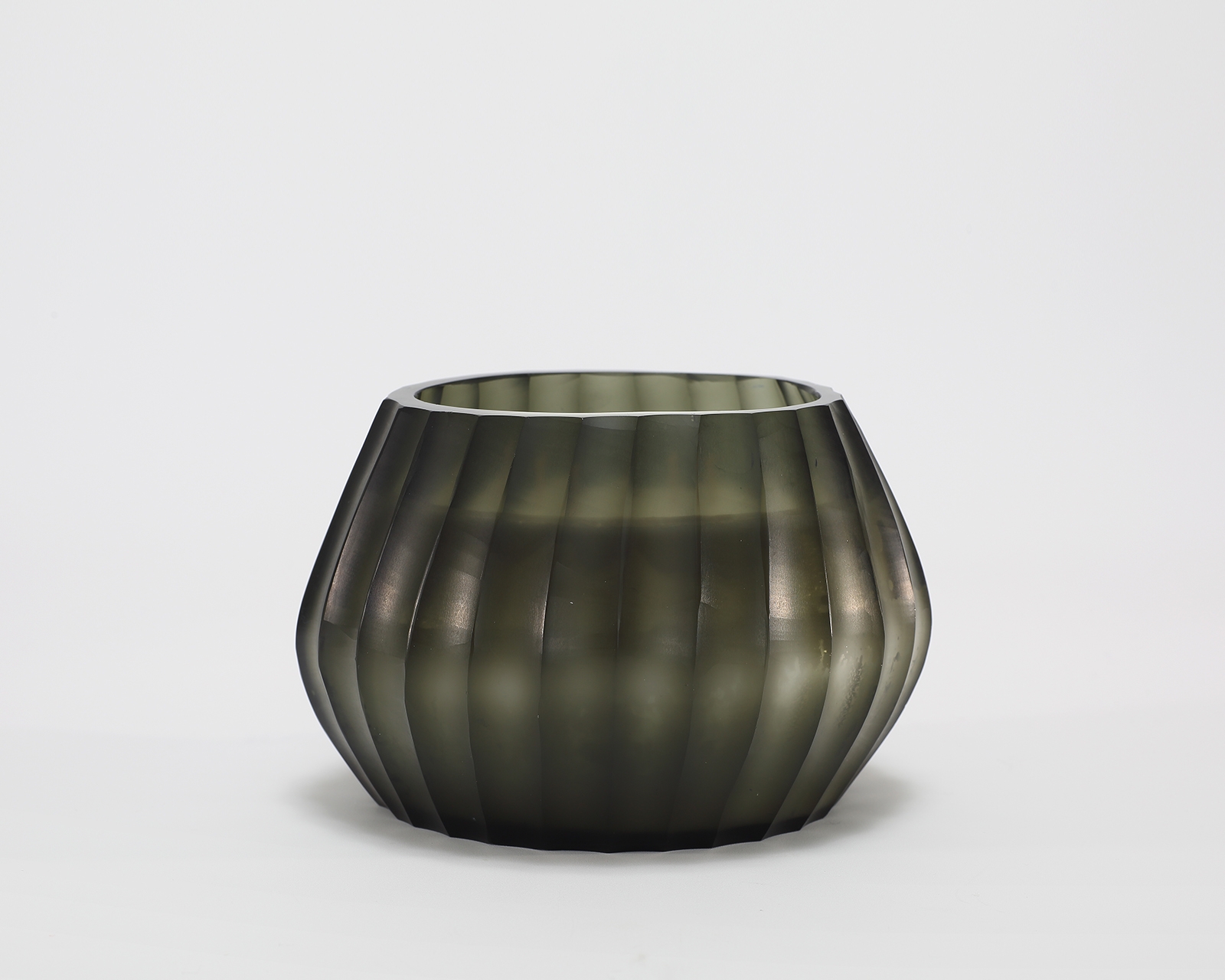 Aura Moss Candle burning, releasing Wanderlust fragrance in hand-carved glass vessel