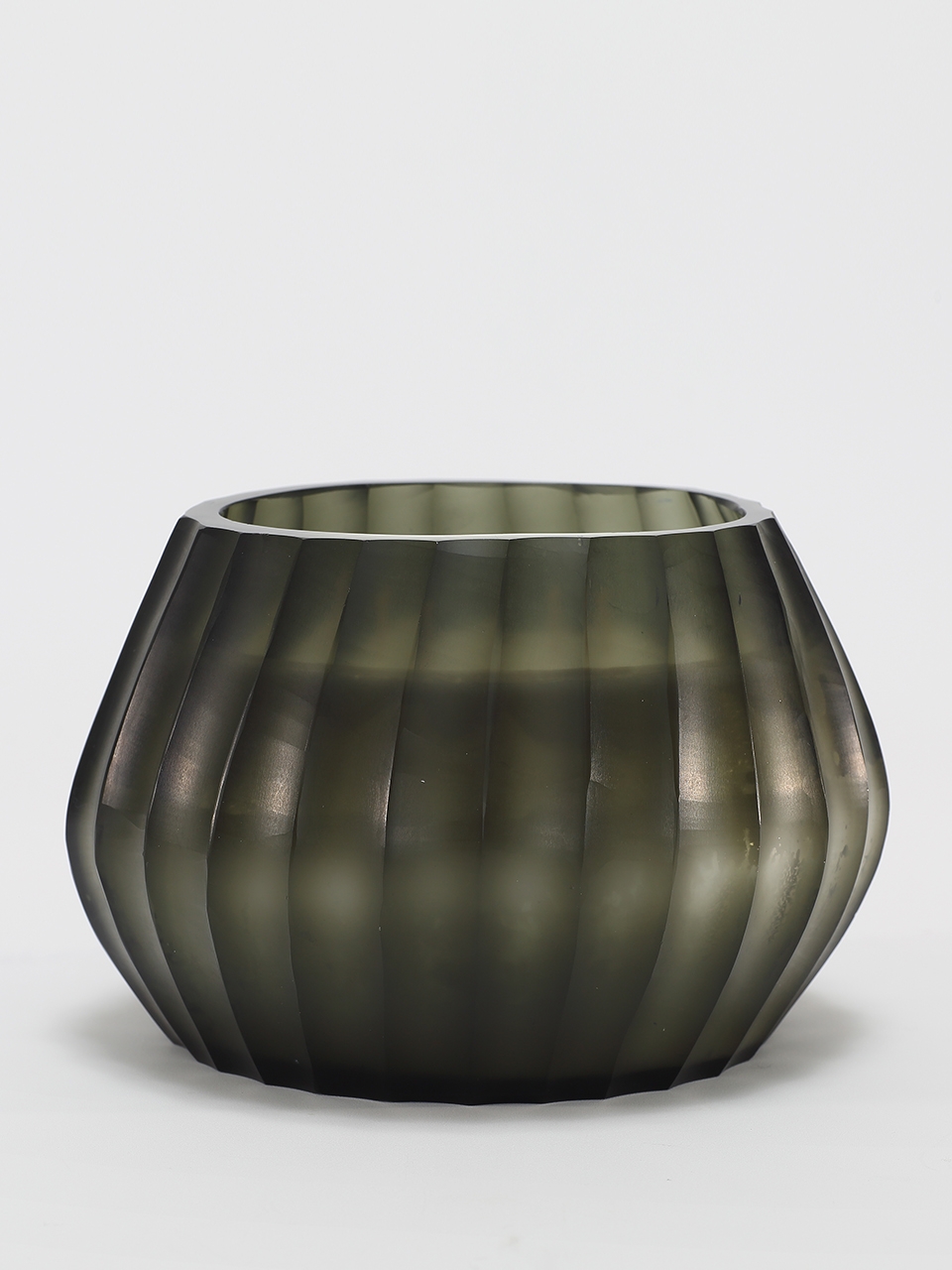 Aura Moss Candle burning, releasing Wanderlust fragrance in hand-carved glass vessel