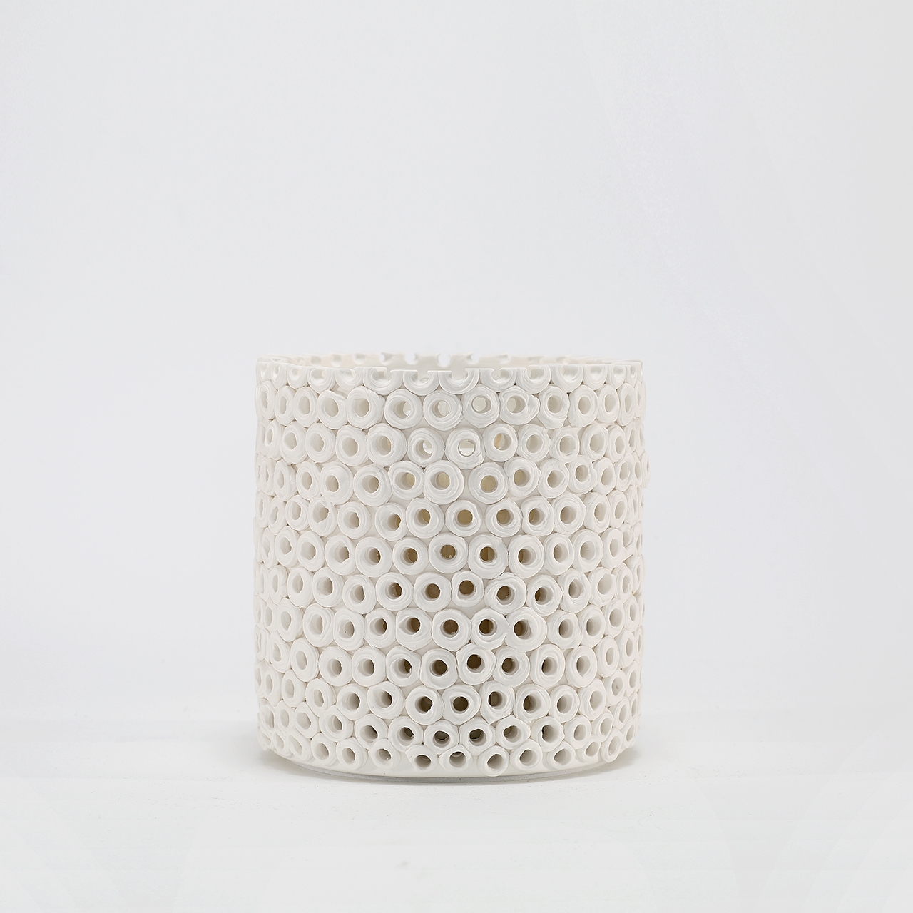 Coralite Ivory Candle burning, releasing Coastal Wilderness fragrance in handcrafted ceramic vessel