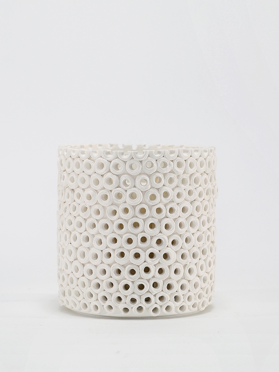 Coralite Ivory Candle burning, releasing Coastal Wilderness fragrance in handcrafted ceramic vessel